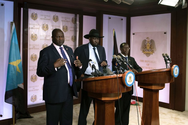 Vice President Riek Machar, left, speaking to reporters with President Salva Kiir, center, and Second Vice President James Wani Igga before shooting erupted outside the presidential palace in Juba on Friday. Credit Charles Atiki Lomodong/Agence France-Presse — Getty Images