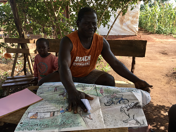 Fine artist and chairperson of the Western Equatorians in one of the settlements, shows a drawing of life in the camp.