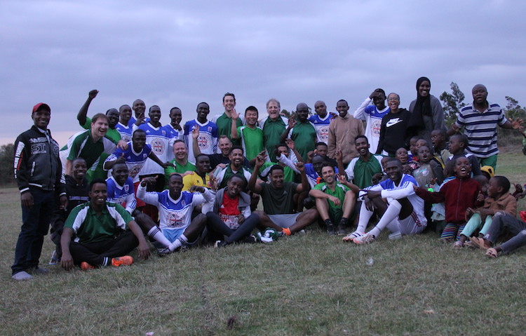 Hotel staff, participants, teachers and local pose after the football match 