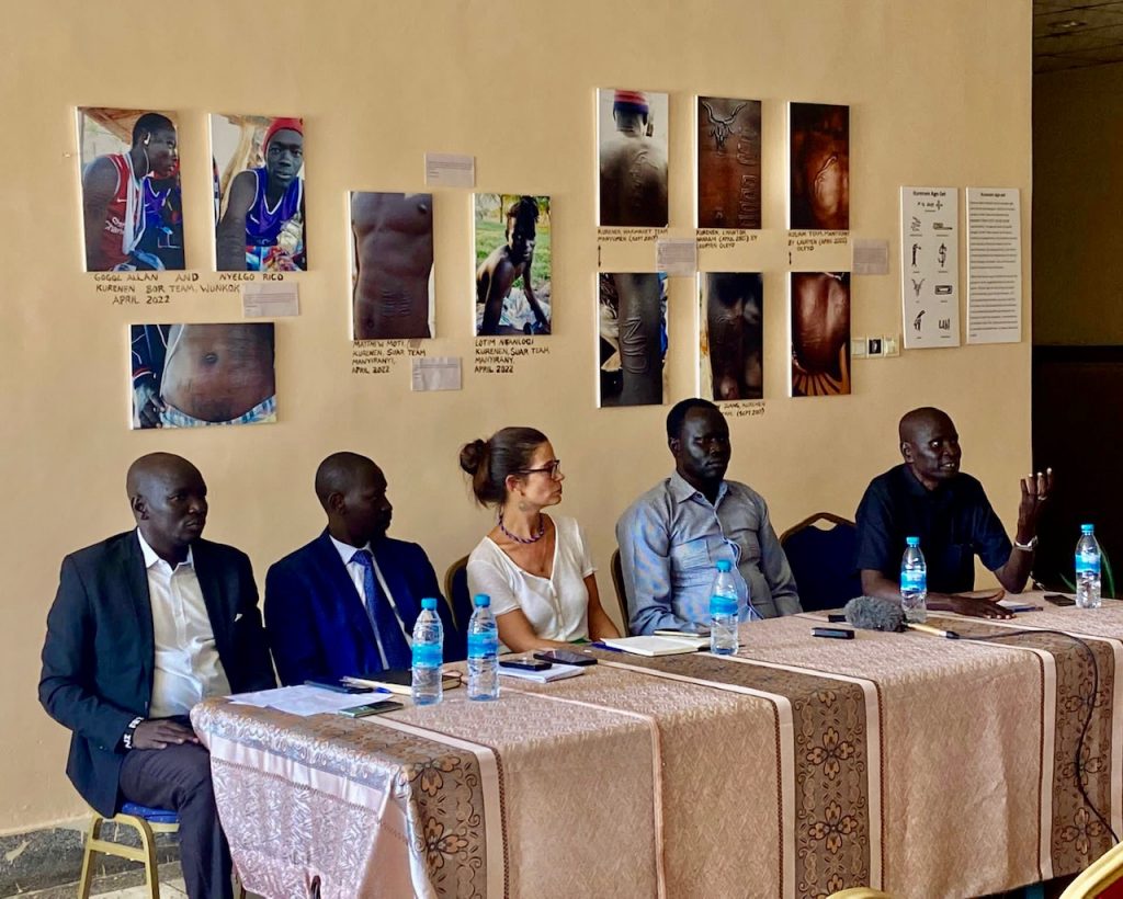 Photograph 2 Panel discussion on ‘Demystifying Murle heritage’, 7 October 2022 at the University of Juba, organised alongside and part of the ‘Stories on the Body’ photo exhibit. From left to right, Peter Lebelek, Joseph Lilimoy, Diana Felix da Costa, Kabacha Oscar Oleyo and John Boloch Kumen (photo by Anna Rowett).
